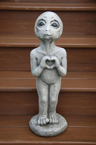Heart Alien statue featuring an extraterrestrial garden sculptures cement